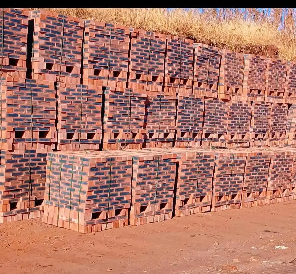 Rows of red common bricks stacked on pallets at the supply yard