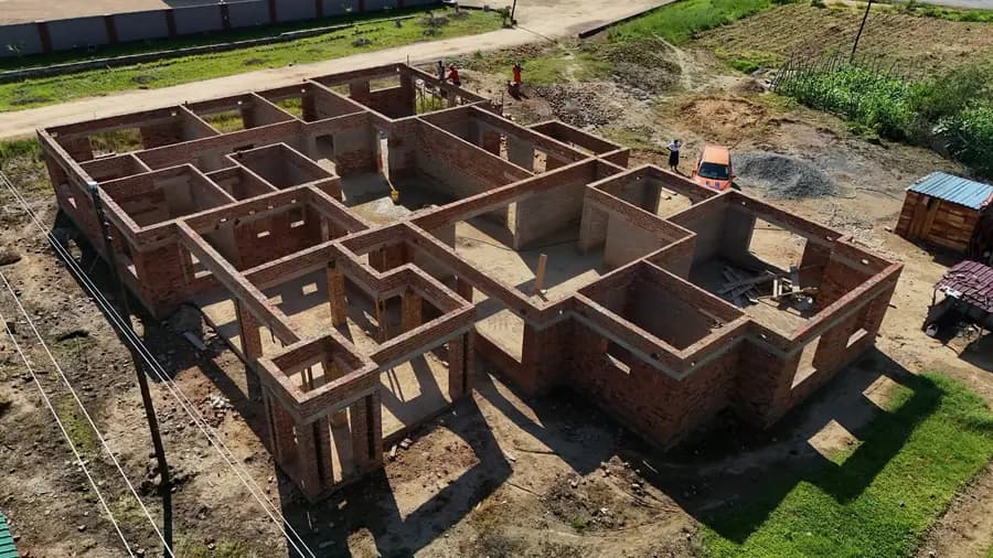 Aerial view of brick walls at floor-slab level marking out every room of a large house