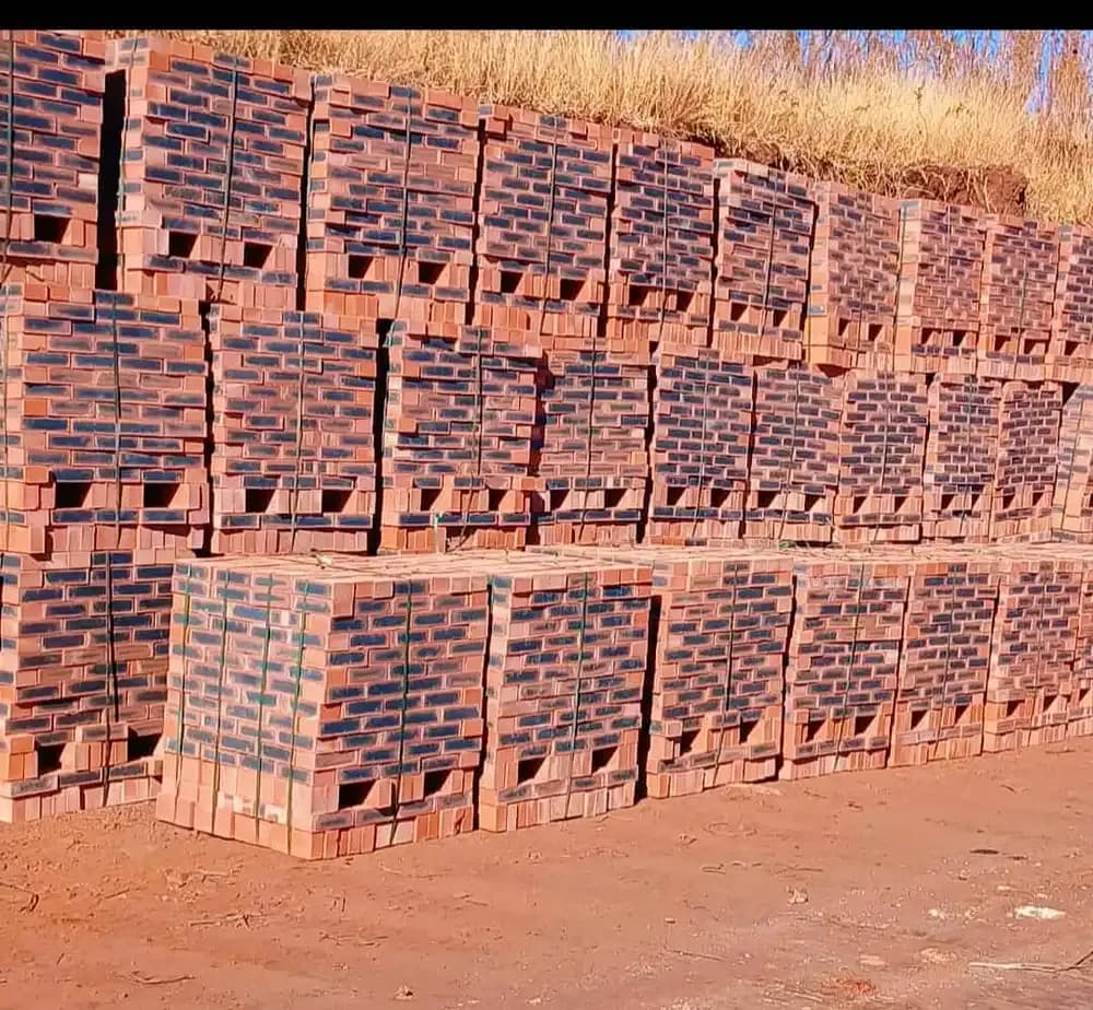 Rows of red common bricks stacked on pallets at the supply yard